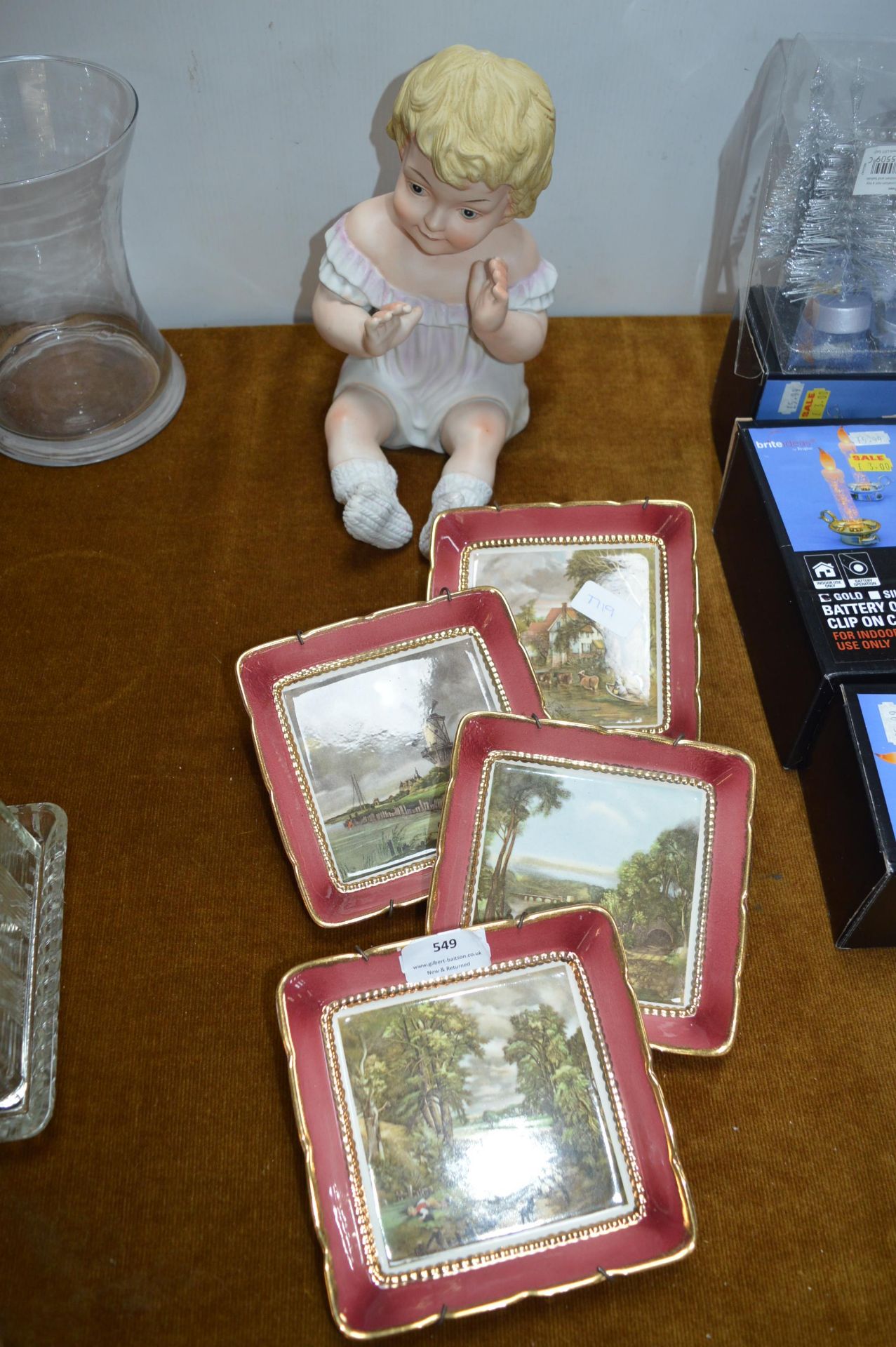 Four Sandland Ware Plates and a Bisque Child