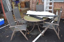 Patio Table with Four Folding Chairs and a Parasol