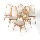 A set of six Ercol light elm and beech Quaker style stick back dining chairs, raised on turned