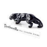 A pottery advertising figure for Pantherella, Fine English Socks, modelled with a panther raised