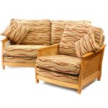 An Ercol elm and bergere two seater sofa, c2007, with wavy striped fabric cushions, 101.5cm wide,