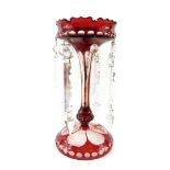 A Continental ruby painted cut glass lustre, with clear prismatic cut drops, 27cm high.