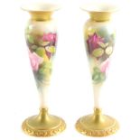 A pair of Royal Worcester blush porcelain vases, c1912, of tapering footed form, painted with roses,