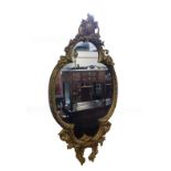 A 19thC gilt wood and gesso wall mirror, of quatrolobe form with shield floral and foliate moulding,
