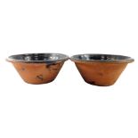 A pair of 19thC brown glazed terracotta dairy bowls, 44.5cm diameter.