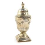 A Victorian silver sugar caster or pepperette, of fluted ogee baluster form, embossed with wreaths