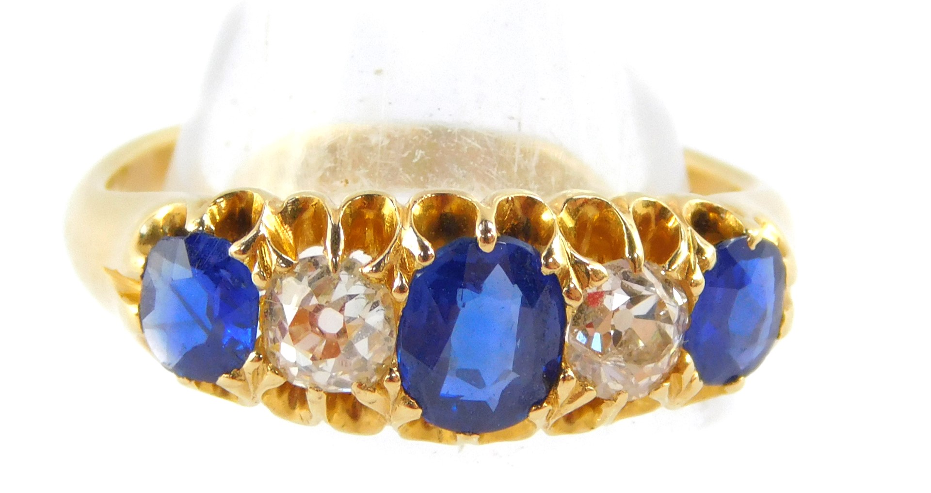 An Edward VII 18ct gold sapphire and diamond fire stone ring, diamonds approx ¼ of a carat, size