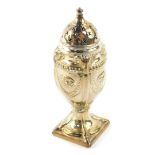 A Victorian silver sugar caster of neo classical form, embossed with ram's heads, wreaths and