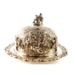 A George IV silver muffin dish and cover, the domed cover with a finial of a seated man with dog,