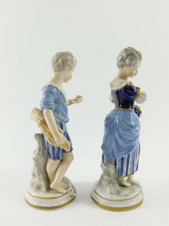 A pair of Unterweissbach 20thC porcelain figures, of a boy and girl, modelled standing with a sheath - Image 2 of 5