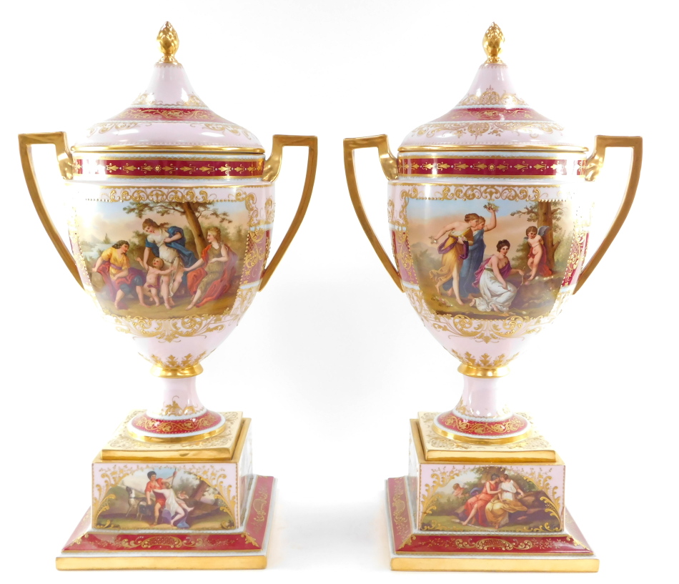 A pair of Vienna style late 19thC porcelain vases and covers, mounted on plinths, of twin handled