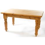 A pine kitchen table, the seven plank top raised on turned and fluted legs, 81cm high, 152cm wide,