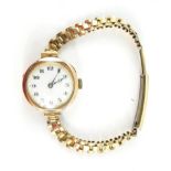 A Buren lady's 9ct gold circular cased wristwatch, white enamel dial bearing Arabic numerals,