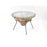 A Franco Albini style mid century wicker circular coffee table, with glass top, contained within a