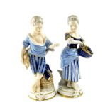A pair of Unterweissbach 20thC porcelain figures, of a boy and girl, modelled standing with a sheath