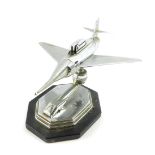 A 1950's Gala Sonic chrome aircraft desk top table lighter, raised on an octagonal plastic base,