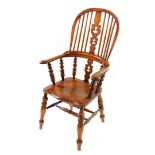 A Victorian oak and elm Windsor chair, with a carved splat and spindle back, solid saddle seat,