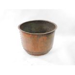 A 19thC copper pot, with riveted decoration, 54cm high, 75cm wide.