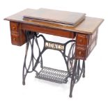 A Victorian Jones treadle sewing machine table, with cast iron base, 78cm high, 91cm wide, 45cm