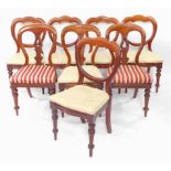 A Harlequin set of Victorian mahogany dining chairs, upholstered in over stuffed red and white