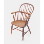 A 19thC oak and elm Windsor carver chair, with spindle back, solid saddle seat, raised on turned