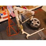 An Oxford Mini 125 hydraulic hoist, together with a Champion equipment stand, and an alloy wheel and