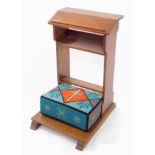 An early 20thC oak church or chapel prayer kneeler, with a single shelf and wool work cushion,