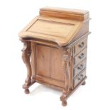 A reproduction hard wood Davenport desk, the lidded rectangular top over a hinged flap, opening to