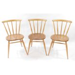 A set of three Ercol blonde elm and beech single dining chairs.