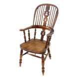 A Victorian oak and elm Windsor chair, with a carved splat and spindle back, solid saddle seat,