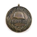 An Austro Hungarian WWI war medal, obverse a helmet and 1914-1918 'Pro Deo a et Patri', reverse