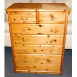 A pine chest, of two over four drawers, raised on a plinth base, 107cm high, 82cm wide, 49cm deep.