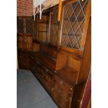 An Old Charm style oak three section lounge cabinet, with lead glazed upper sections, and an