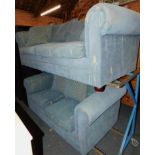 A three seater Chesterfield style sofa, upholstered in a blue fabric with leaf pattern, together