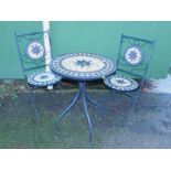 A metal patio table and two chairs, with decorative tile tops, table 75cm high, 80cm diameter,