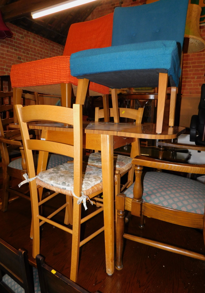 A 1950's Formica drop leaf table, 75cm high, 106cm wide, 60cm deep., together with two rush seated