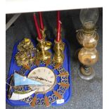 An Estyma wall clock, brass candlesticks, oil lamps and ornaments. (1 tray plus)