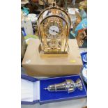 A Rhythm quartz mantel clock, together with a silver plated sugar sifter, boxed. (2)