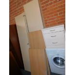 A flat pack beech effect four door wardrobe, together with a similar bedside cabinet, 53cm high,