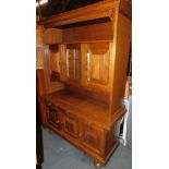 An oak dining room dresser, with cupboards above two drawers and two further cupboards, 192cm