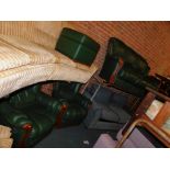 A green leather three piece suite with wood trim.