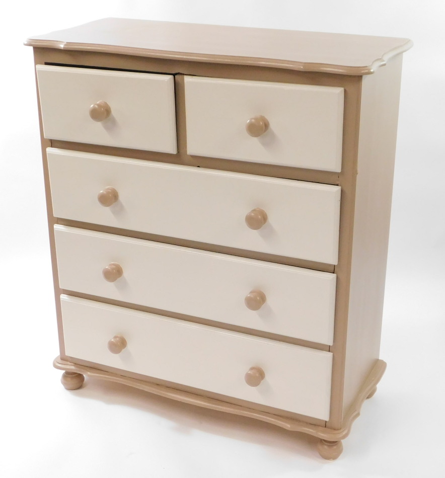 A pine chest, of two over three drawers, painted beige and white, raised on turned feet, 105cm high,