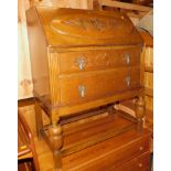 A 20thC oak bureau, with floral carved fall front above two drawers, 101cm high, 82cm wide, 47cm