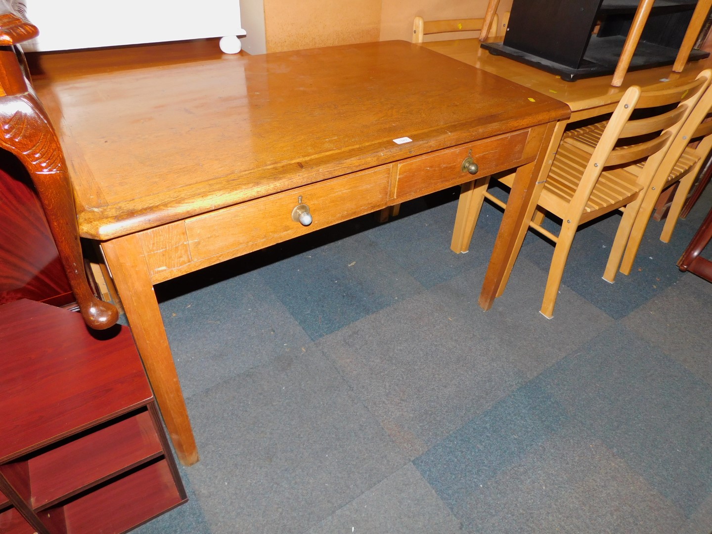 An oak and oak veneered Abbess style two drawer desk, 76cm high, 121cm wide, 76cm deep.