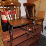 A pair of 19thC beech spindle back kitchen chairs.