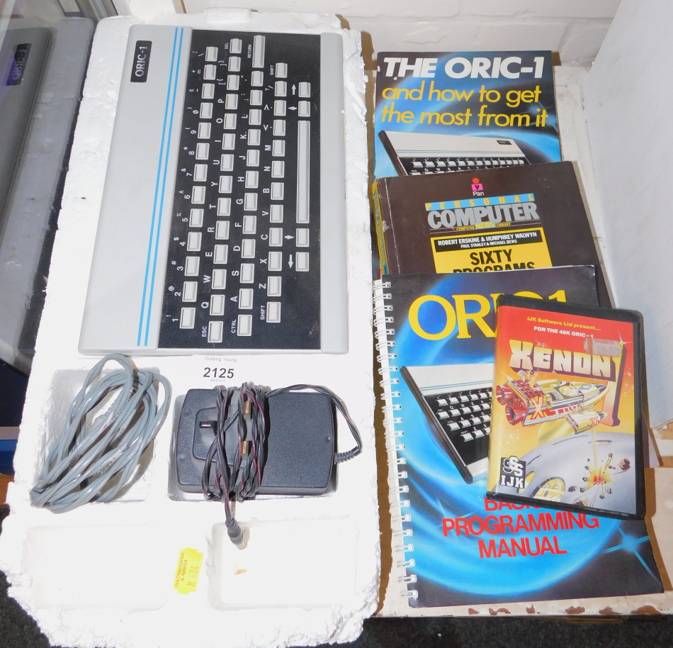 An Oric-1 personal computer together with a basic programming manual, sixty programmes for the