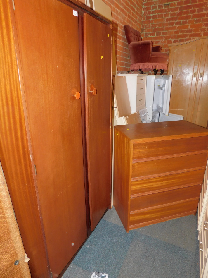 A Castle teak double wardrobe, 173cm high, 92cm wide, 55cm wide., together with a similar teak chest