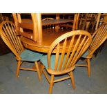 An oak and oak veneered circular kitchen table, 75cm high, 108cm diameter., together with four