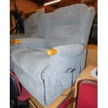 An electric rise and recline armchair, upholstered in a blue grey fabric.