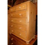 A waxed pine chest of two over four drawers, raised on bun feet, 102cm high, 91cm wide, 46cm deep.